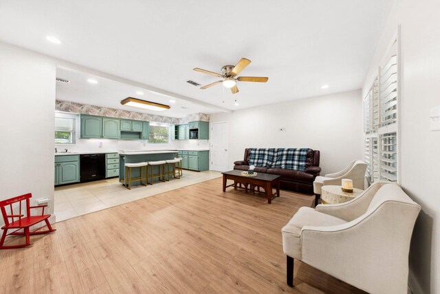 tiled living room featuring sink and ceiling fan