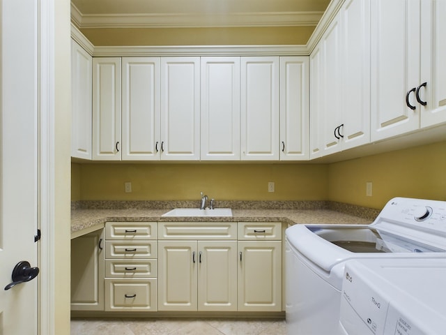 washroom featuring cabinets, washing machine and dryer, crown molding, and sink