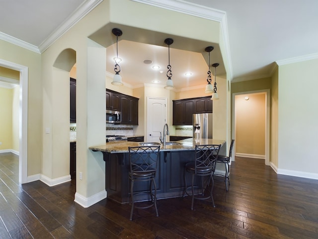 kitchen featuring a breakfast bar area, stone counters, stainless steel appliances, dark wood-type flooring, and dark brown cabinets