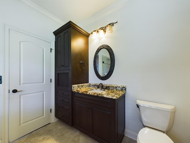 bathroom with crown molding, toilet, vanity, and tile patterned flooring