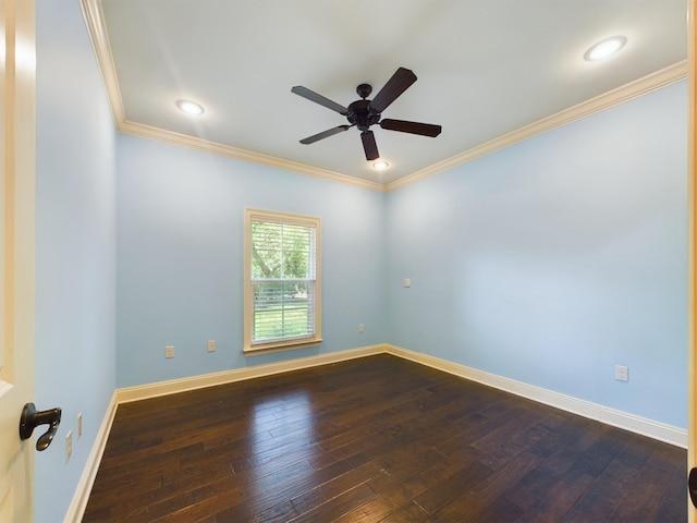 spare room with ceiling fan, ornamental molding, dark wood-style flooring, and baseboards