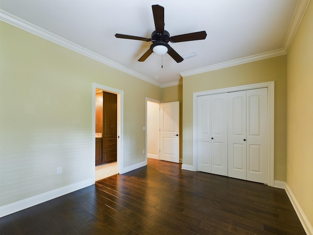 unfurnished bedroom with crown molding, a closet, dark wood-type flooring, ceiling fan, and baseboards