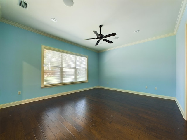 empty room with dark wood-style floors, visible vents, and crown molding