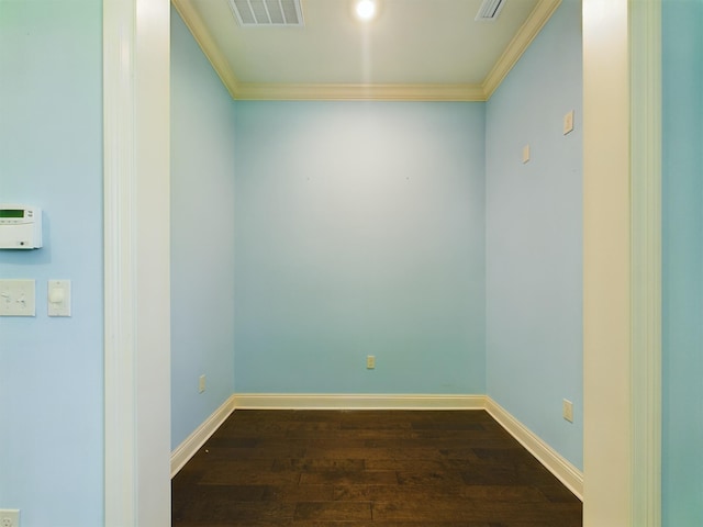 unfurnished room with baseboards, crown molding, visible vents, and wood finished floors