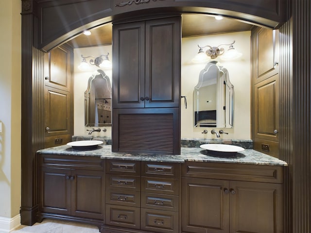 bathroom with dual bowl vanity and ornamental molding