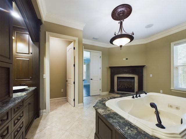 full bath with visible vents, baseboards, ornamental molding, a whirlpool tub, and a glass covered fireplace