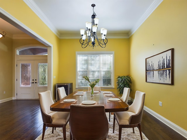 dining space featuring dark wood-type flooring, a chandelier, and crown molding