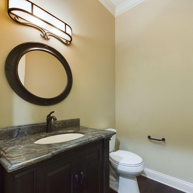 bathroom with crown molding, toilet, and vanity