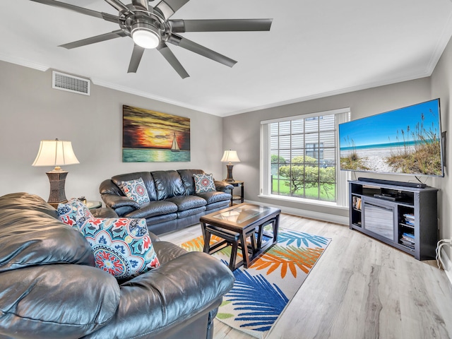 living room with crown molding, ceiling fan, and light hardwood / wood-style floors