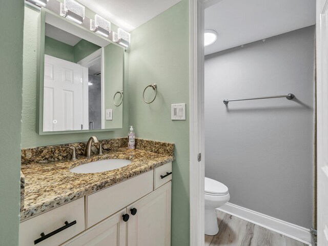 452 N Driftwood Bay Unit 96B, Miramar Beach, FL 32550 - bathroom featuring toilet, vanity, baseboards, and wood finished floors