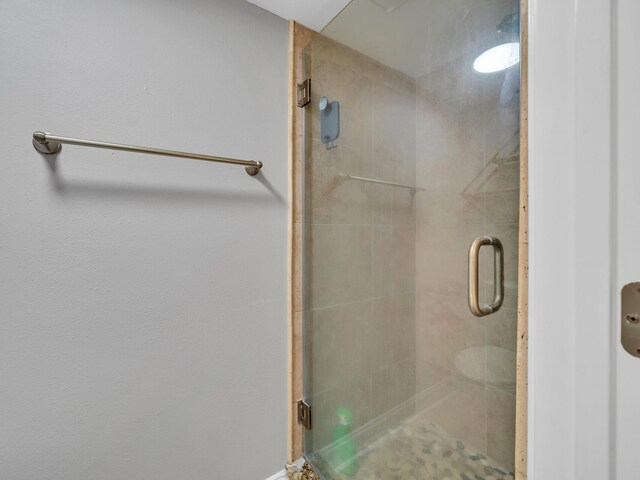 bathroom featuring a shower with door