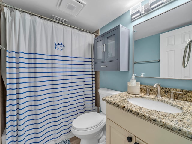 bathroom featuring curtained shower, toilet, hardwood / wood-style flooring, and vanity