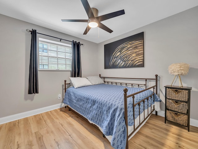 bedroom with hardwood / wood-style floors and ceiling fan