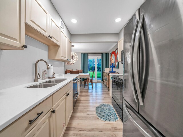 452 N Driftwood Bay Unit 96B, Miramar Beach, FL 32550 - kitchen with light wood-type flooring, range, a sink, freestanding refrigerator, and dishwashing machine