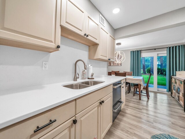 452 N Driftwood Bay Unit 96B, Miramar Beach, FL 32550 - kitchen featuring light countertops, ornamental molding, a sink, light wood-style floors, and pendant lighting