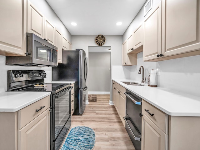 452 N Driftwood Bay Unit 96B, Miramar Beach, FL 32550 - kitchen featuring dishwasher, light wood finished floors, black range with electric stovetop, stainless steel microwave, and a sink