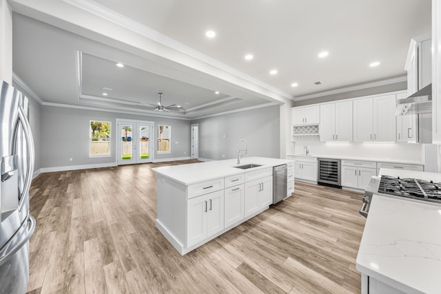 kitchen featuring wine cooler, white cabinetry, and light hardwood / wood-style flooring