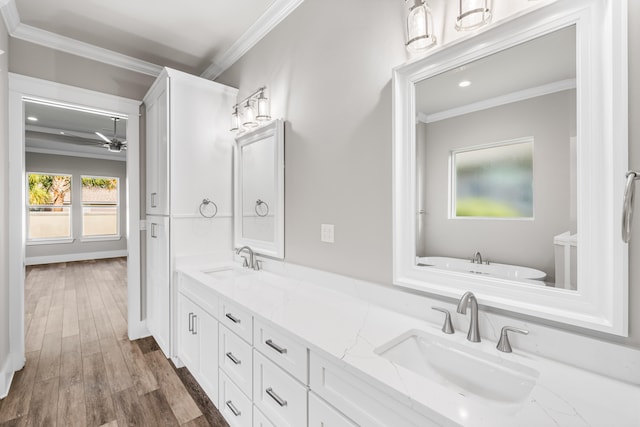 bathroom with crown molding, hardwood / wood-style flooring, vanity, and ceiling fan