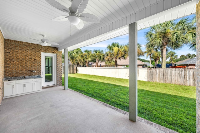 view of patio with ceiling fan and sink