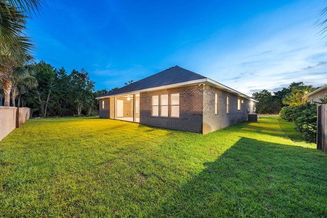 view of property exterior with cooling unit and a yard