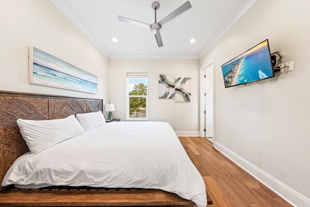 bedroom with ceiling fan, hardwood / wood-style flooring, and ornamental molding