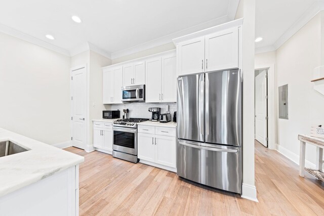 kitchen featuring decorative backsplash, light hardwood / wood-style flooring, stainless steel appliances, and white cabinets