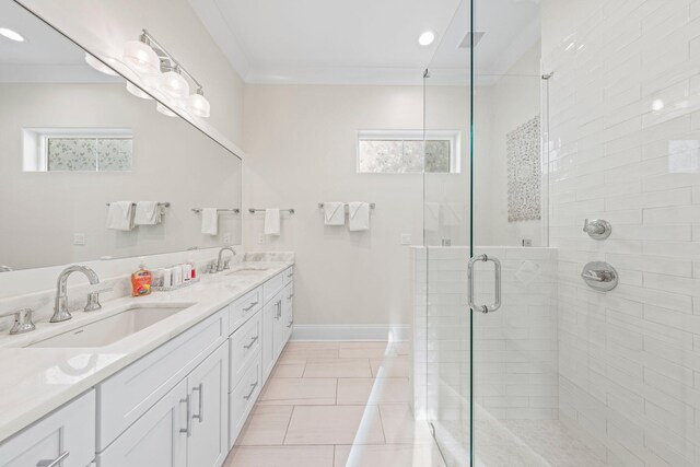 bathroom with tile patterned floors, double sink vanity, crown molding, and an enclosed shower