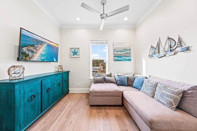 living room with ceiling fan, light wood-type flooring, and crown molding