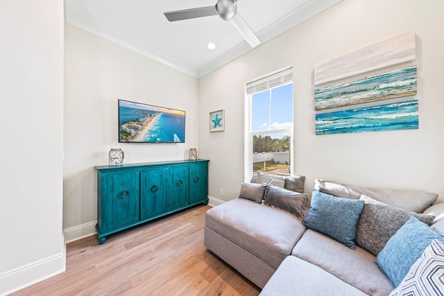 living room with light hardwood / wood-style flooring, ornamental molding, and ceiling fan