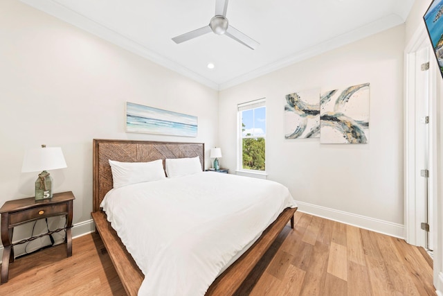 bedroom with light hardwood / wood-style floors, ornamental molding, and ceiling fan