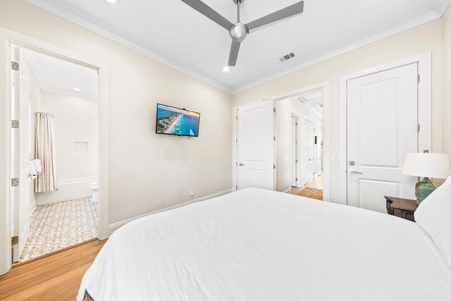 bedroom with light hardwood / wood-style floors, ensuite bath, ceiling fan, and crown molding