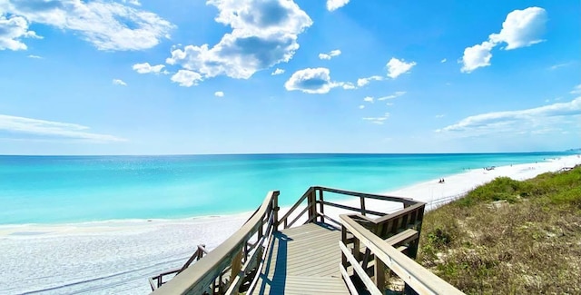 view of property's community with a water view and a view of the beach