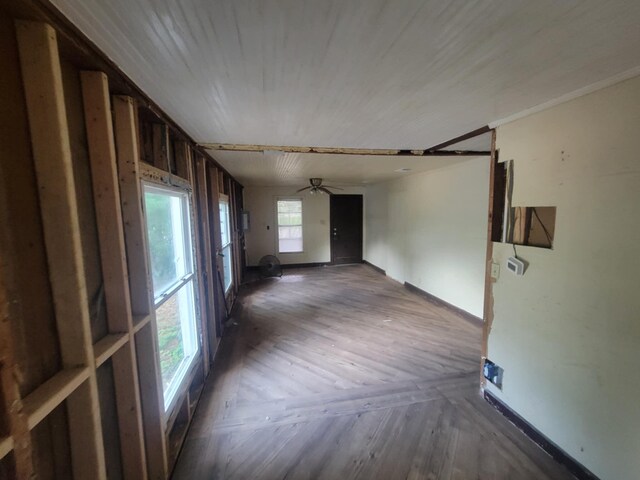 unfurnished room featuring ceiling fan, a healthy amount of sunlight, and parquet flooring