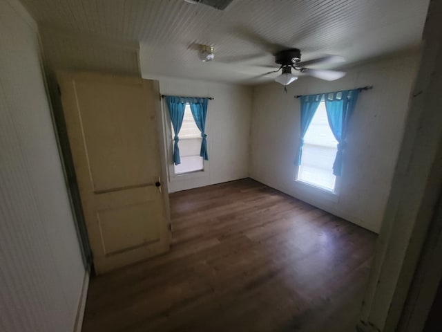 empty room with ceiling fan and hardwood / wood-style floors