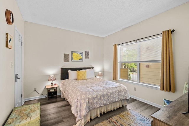 bedroom featuring dark wood-type flooring and a textured ceiling