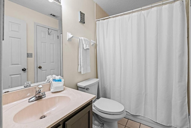 full bathroom with vanity, tile patterned floors, a textured ceiling, and toilet