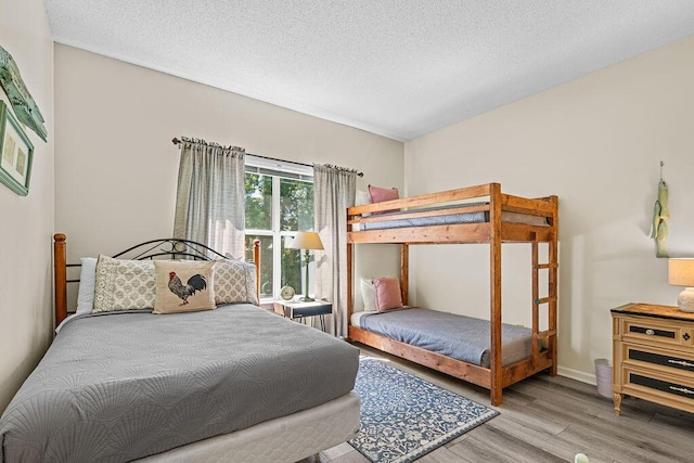 bedroom with hardwood / wood-style flooring and a textured ceiling