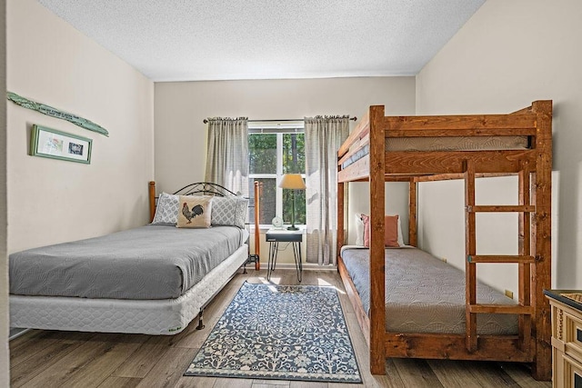 bedroom featuring wood-type flooring and a textured ceiling