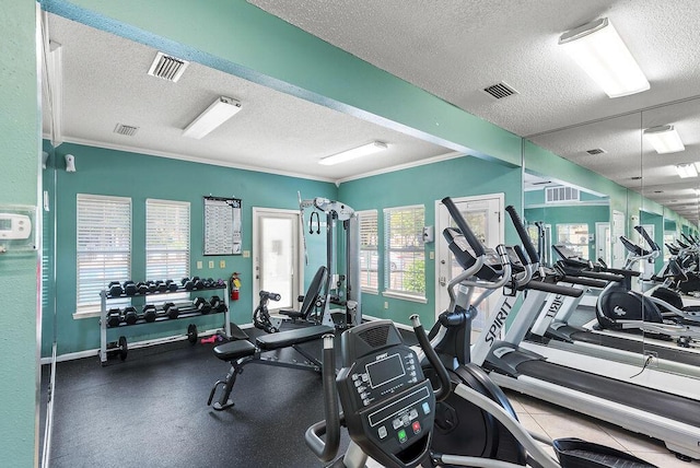 workout area with crown molding and a textured ceiling