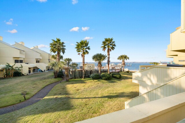 view of home's community featuring a water view and a yard