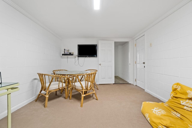 dining area featuring crown molding and carpet flooring