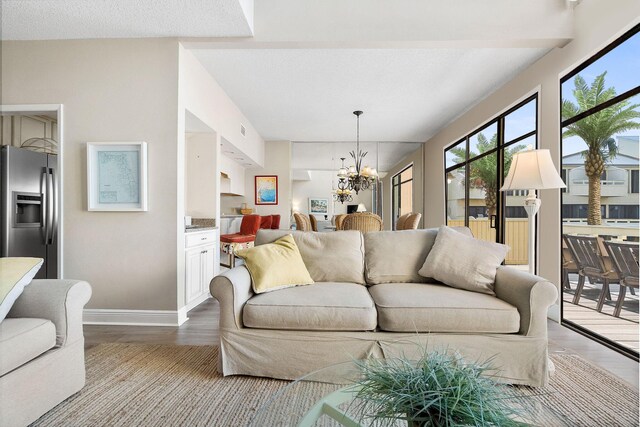 living room with a notable chandelier and hardwood / wood-style floors