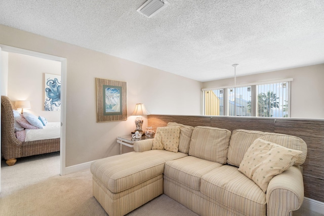 living room featuring light colored carpet and a textured ceiling