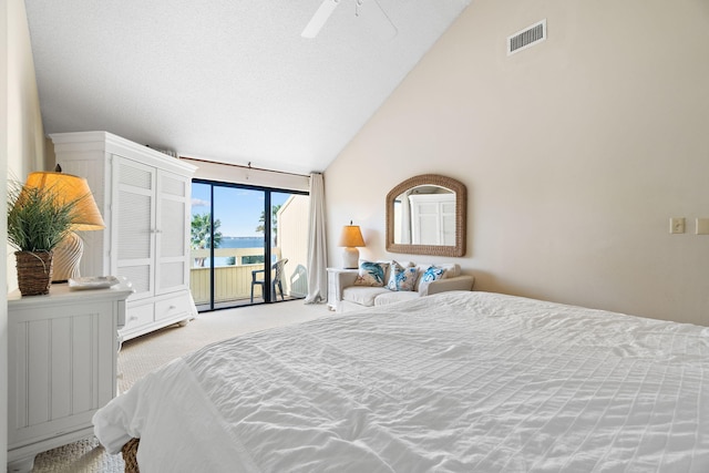 carpeted bedroom with a water view, high vaulted ceiling, access to exterior, and ceiling fan