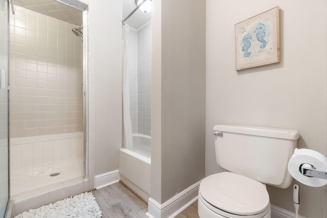 bathroom featuring a tile shower, hardwood / wood-style flooring, and toilet