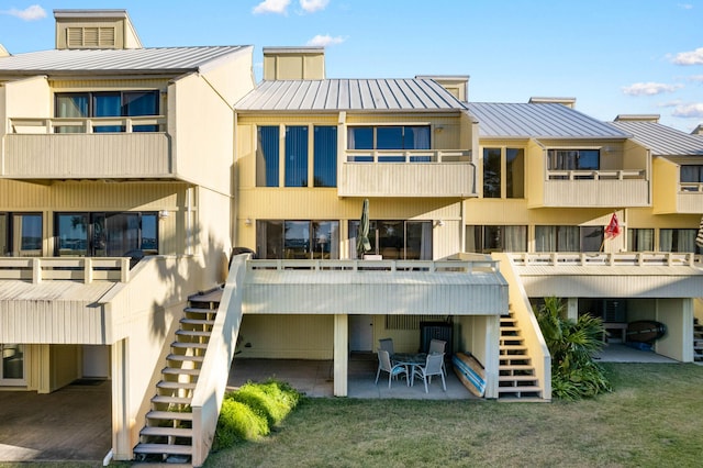 back of property featuring a patio and a yard