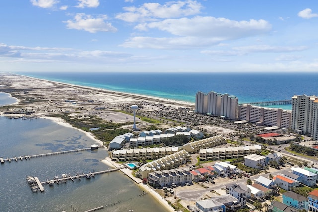 birds eye view of property featuring a water view and a beach view