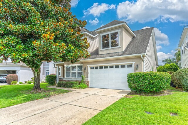 view of front facade with a garage and a front lawn