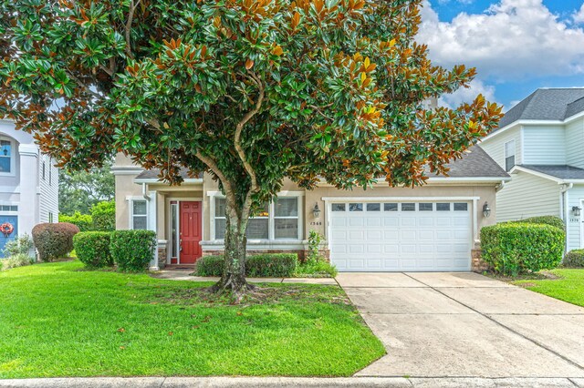 obstructed view of property with a garage and a front yard