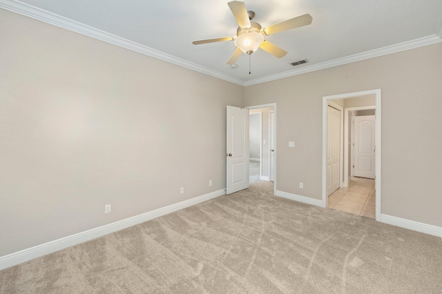 unfurnished bedroom featuring crown molding, light colored carpet, and ceiling fan